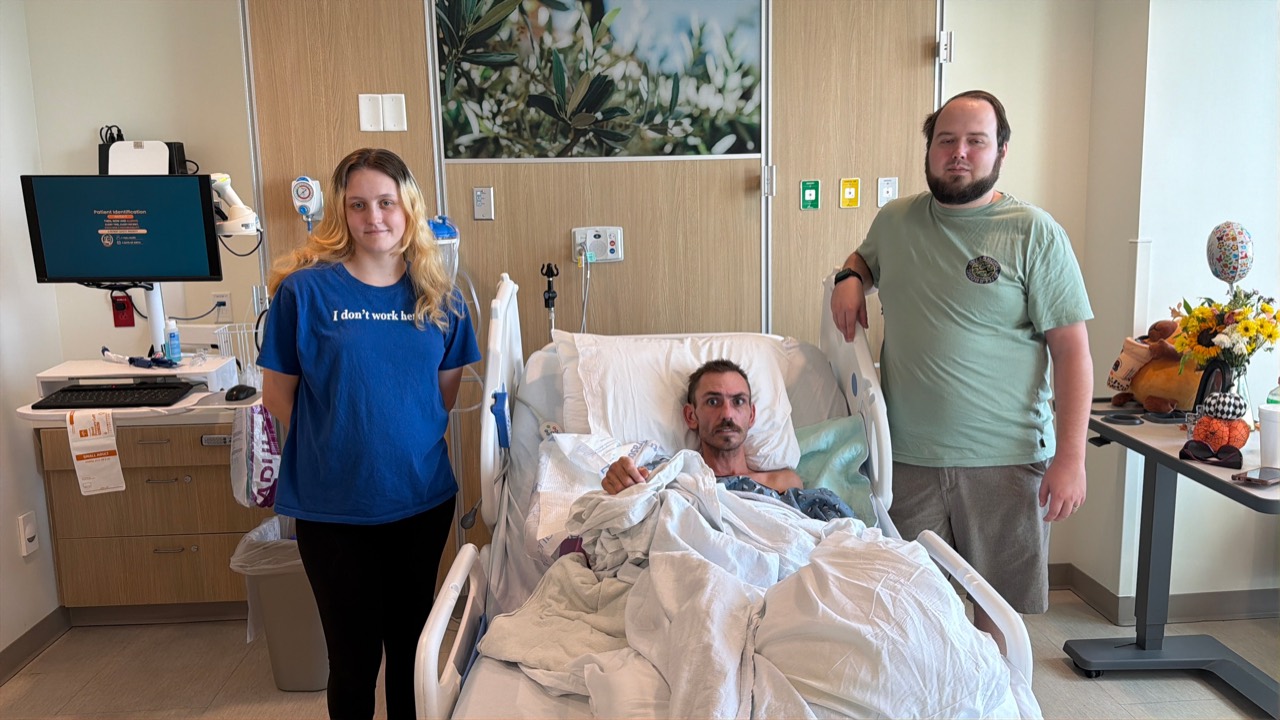 FYND owners Abigail and Malachi visiting Devin in his hospital room during his recovery