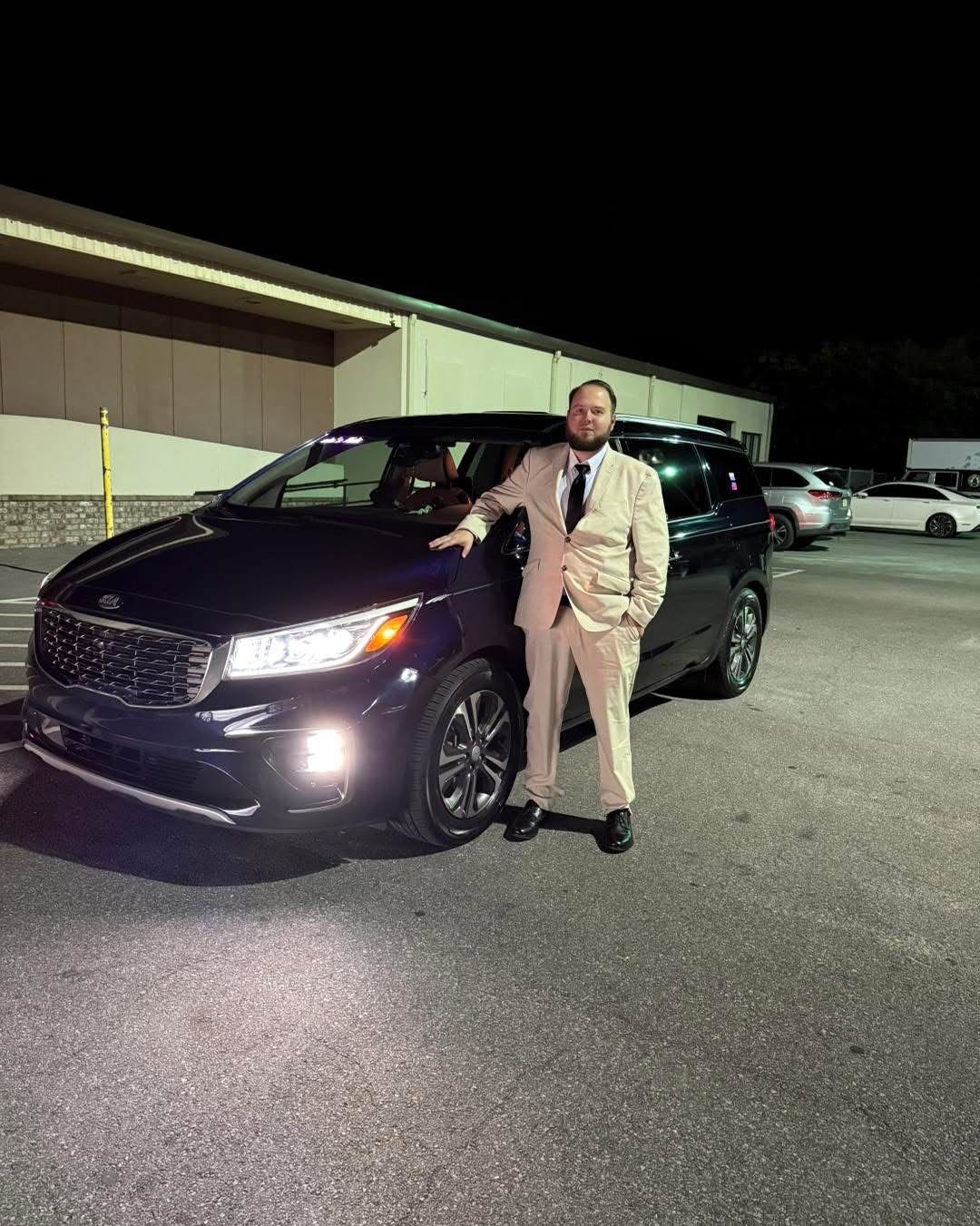 Malachi, a FYND owner and professional driver, standing beside his vehicle in Pensacola