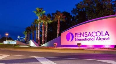Pensacola International Airport entrance sign illuminated at night